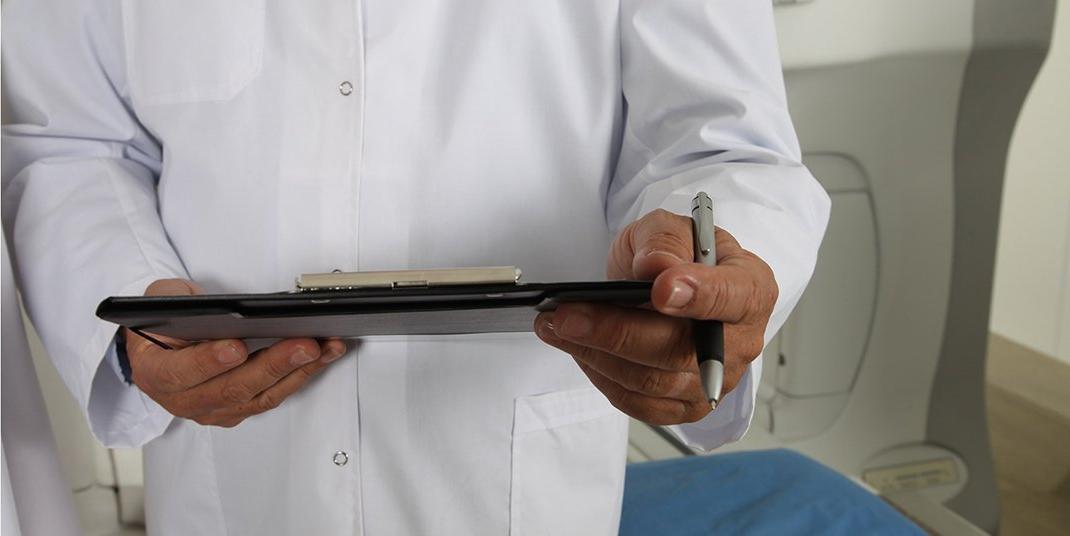 A doctor holding a clipboard